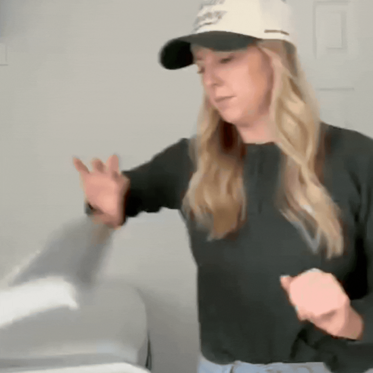 Woman frustrated pulling fur-covered laundry from washer